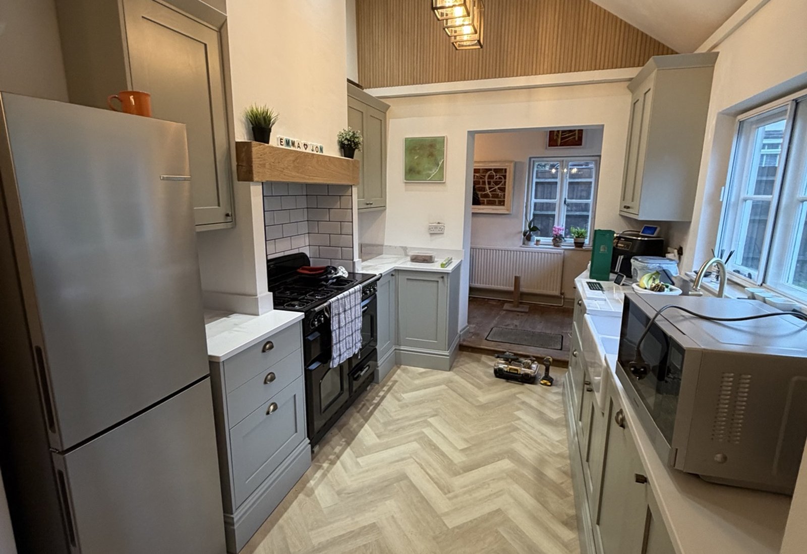 Full galley kitchen with vaulted ceiling and herringbone flooring